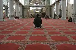 A man prays in the mosque in 2008