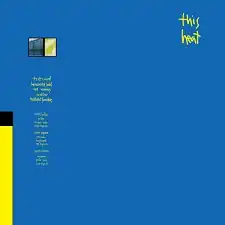 A blue background with the words "This Heat" written in small, yellow handwritten font in the top-right quarter of the image.