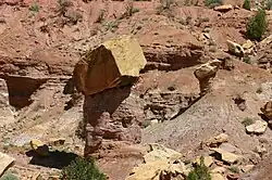 An ancient rockfall which protected the rock records beneath its impact site from further large scale erosion. Taken along Burr Trail, Grand Staircase–Escalante National Monument, Utah, US.