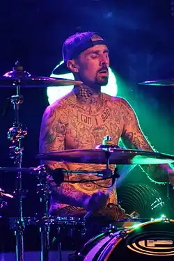 A man drumming while on stage.