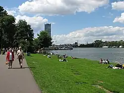 People sunbathing along the Spree River in Treptow