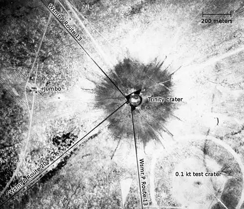An aerial photograph of the Trinity crater shortly after the test[g]