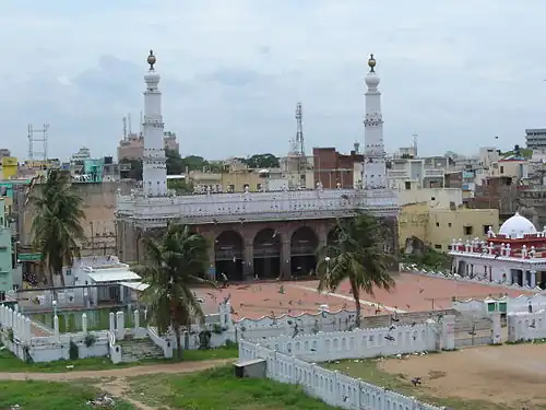 Entrance to the mosque with dome, water tank and two minarets