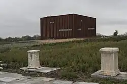 Troy Museum aboveground. Most of the entire field in which it sits roofs the underground galleries, work, and storage spaces. These are accessed via ramps not shown. There are also outdoor display spaces.