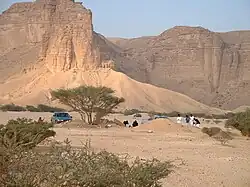 People at the base of the escarpment