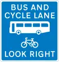 Contra-flow bus lane which pedal cycles may also use with traffic approaching from the right (reminder for pedestrians)