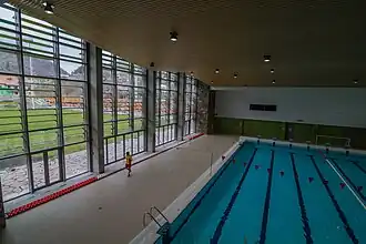 Indoor pool with outdoor playing field