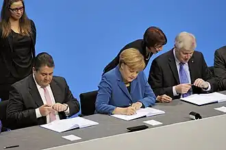 Angela Merkel and SPD leaders signing the 2013 grand coalition deal