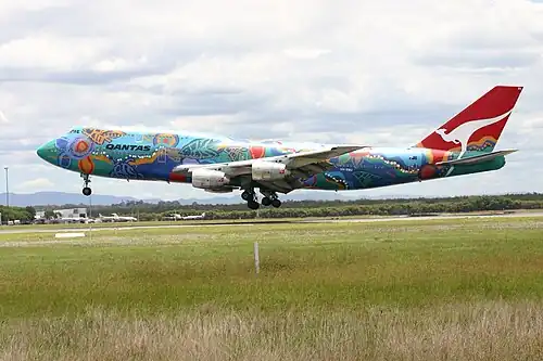 A Boeing 747–300 in 2004 wearing the Nalanji Dreaming livery. The aircraft carried the colour scheme from 1995 to 2005.