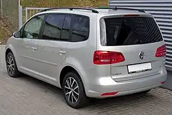 Rear-three-quarter view of a facelifted European Touran; on this model the taillight cluster is partially integrated into the rear hatch