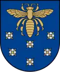 A coat of arms depicting a golden scarab with wings and legs outstretched flying over six purple flowers all on a blue background