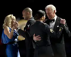 Joe and Jill Biden dancing with members of the U.S. armed forces at the Commander in Chief's Ball. Silk blue gown by Vera Wang.[102]