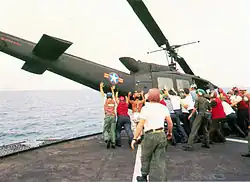 RVNAF Huey is pushed overboard from USS Midway