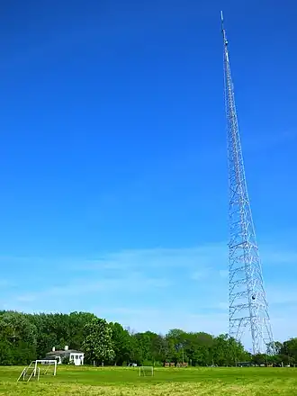 View across soccer field of WITI TV Tower and Benjamin Church House at south end of park