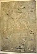 Wall relief depicting an eagle-headed and winged man, Apkallu, from Nimrud.