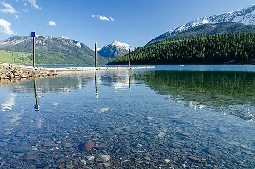 North end of lake. Public dock visible in midground, Bonneville Mountain at center and Chief Joseph Mountain at right