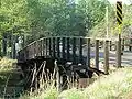A wooden bridge crossing the railroad in eastern Waverly