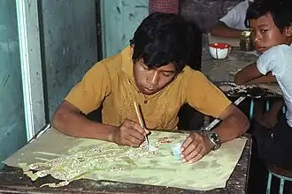 Painting the wayang kulit in a Yogyakarta factory