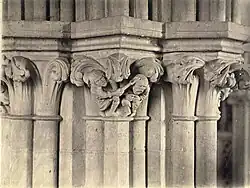 Detail of column capital sculpture, showing a farmer hitting a fruit thief Wells Cathedral