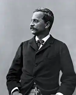 Black and white photograph of 19th-century Hawaiian man in Western suit, facing left