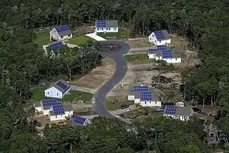 A completed community built with photovoltaic systems allowing for lower home energy costs.