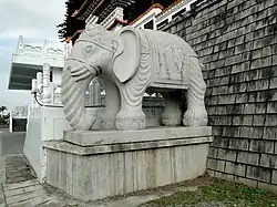 A statue of a white elephant in front of SyuentzangTemple.