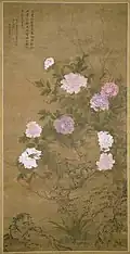 Painting of white, pale pink, and lavender peonies on shrub on a vertical scroll. The tree has a brown trunk and deep green leaves, and the brightness of the flowers are contrasted against the background.