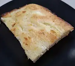 Baked dessert on a black plate.